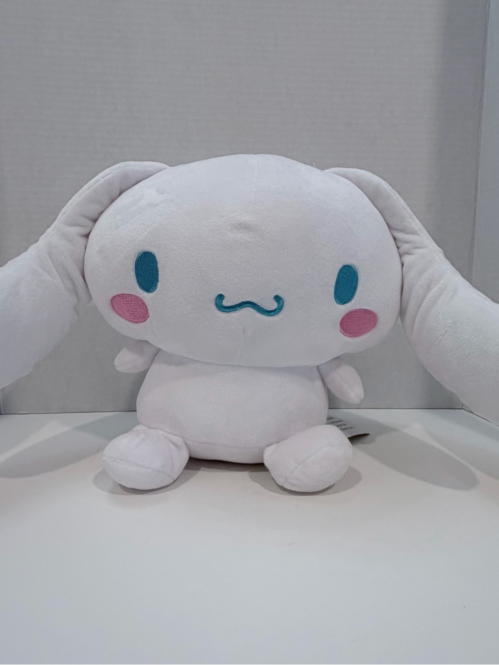 Sanrio White Cinnamoroll Plush with Teal Eyes and Pink Cheeks